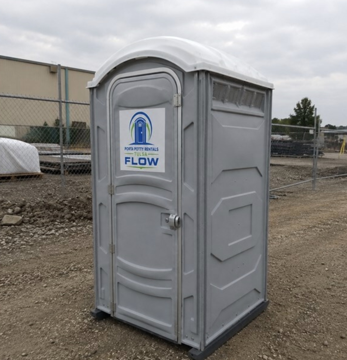 Grey portable toilet on site